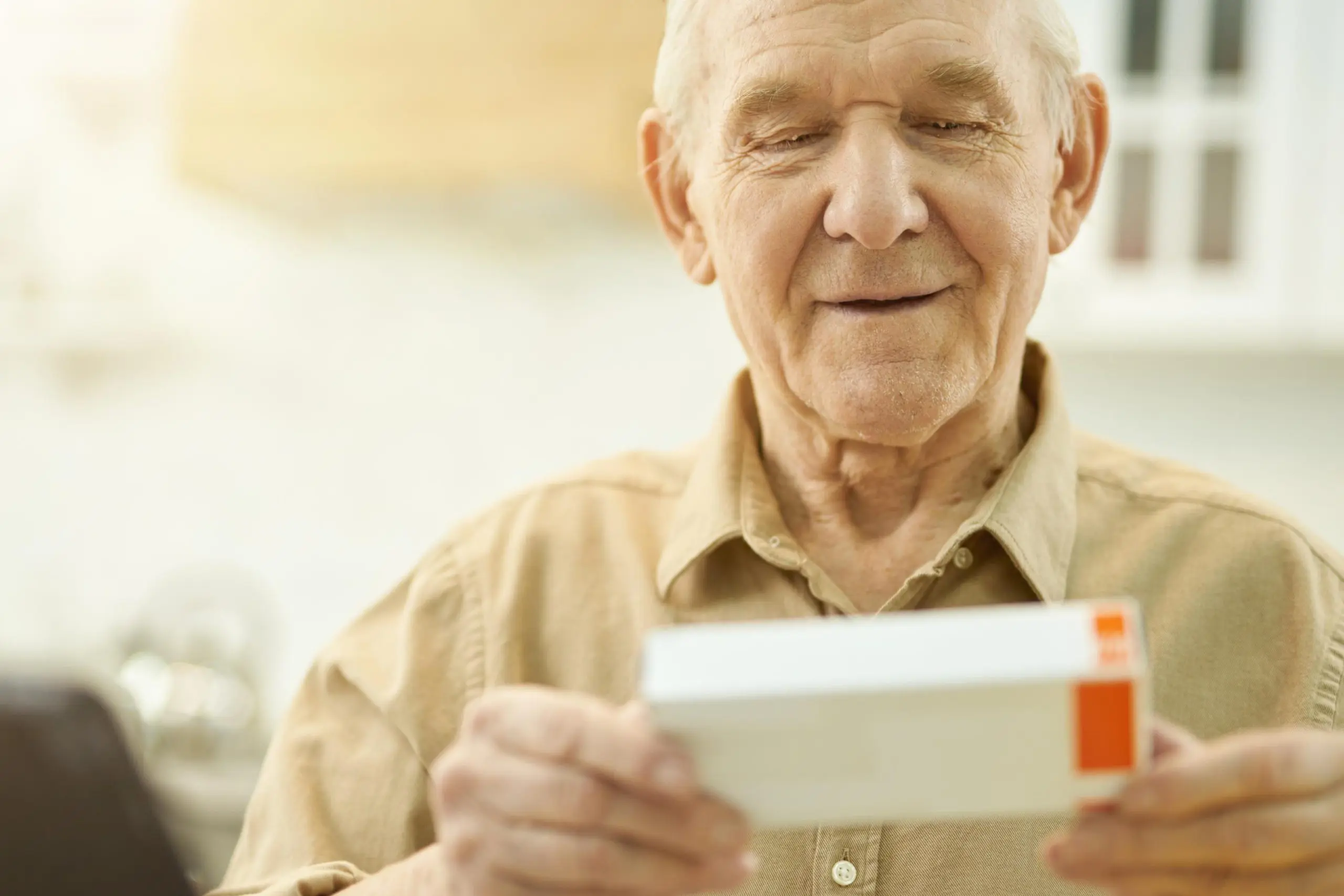 Senior reviewing medication under Medicare Part D prescription plans and coverage details, iHealth Insurance