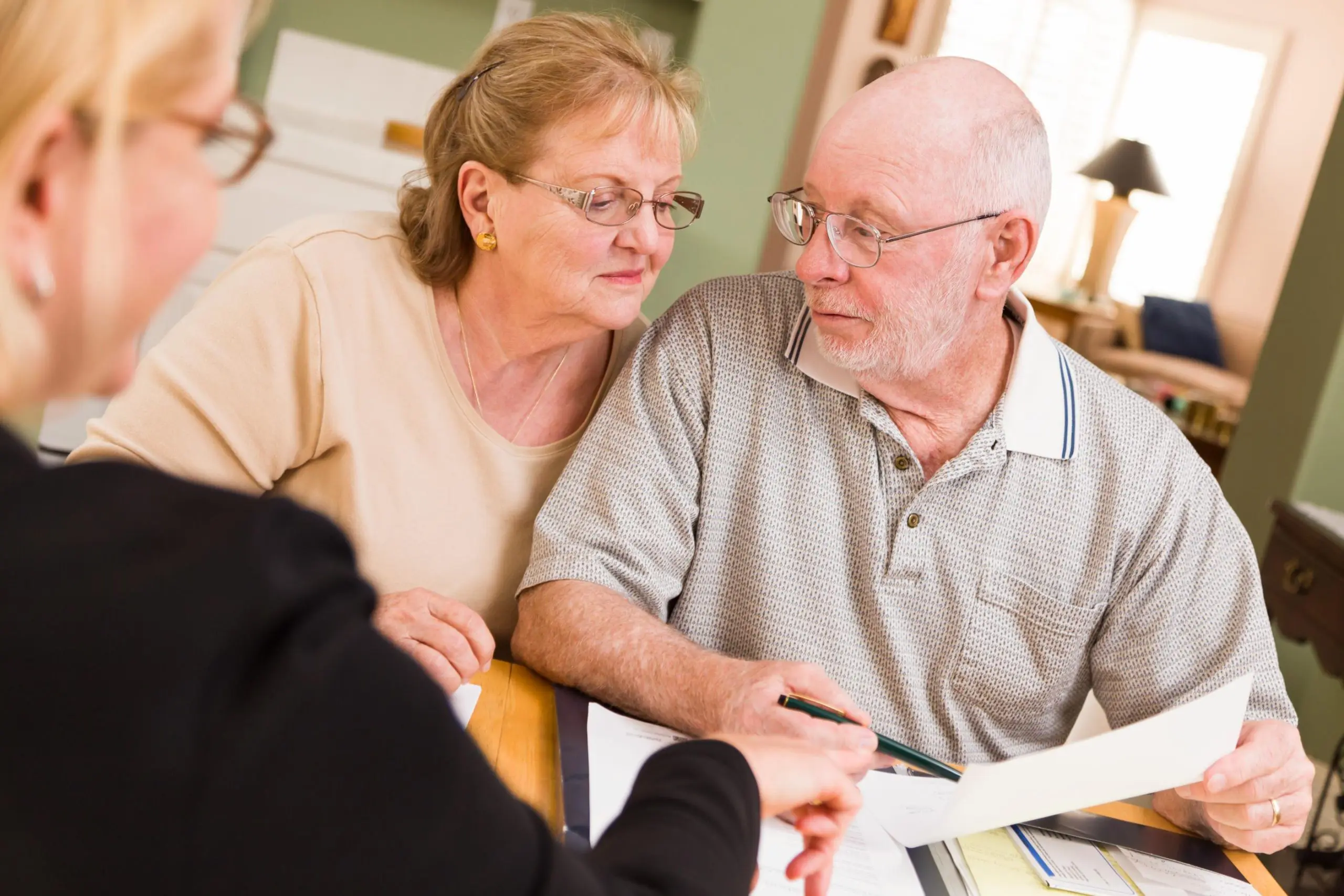 Senior couple reviewing coverage details with guidance on advantages of Medicare Part C, iHealth Insurance